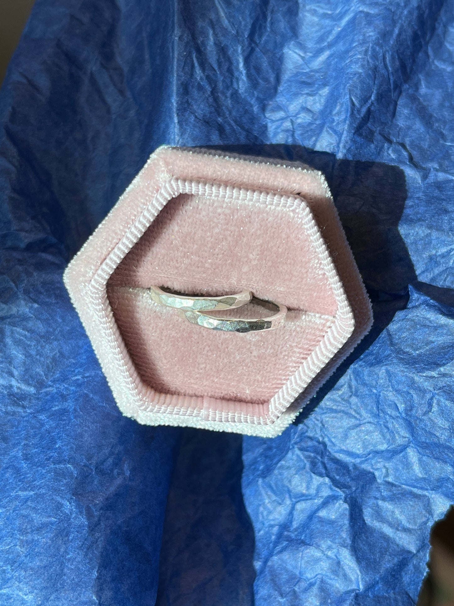 the two hammered bands pictured in a pink velvet ring box