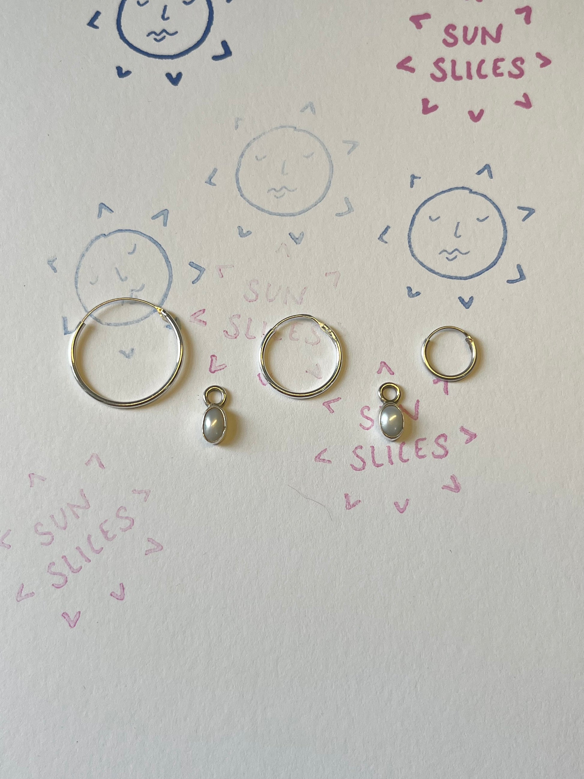 the pearl drops pictured with the hoop options available - 20mm, 16mm and 10mm. Pictured against logo.