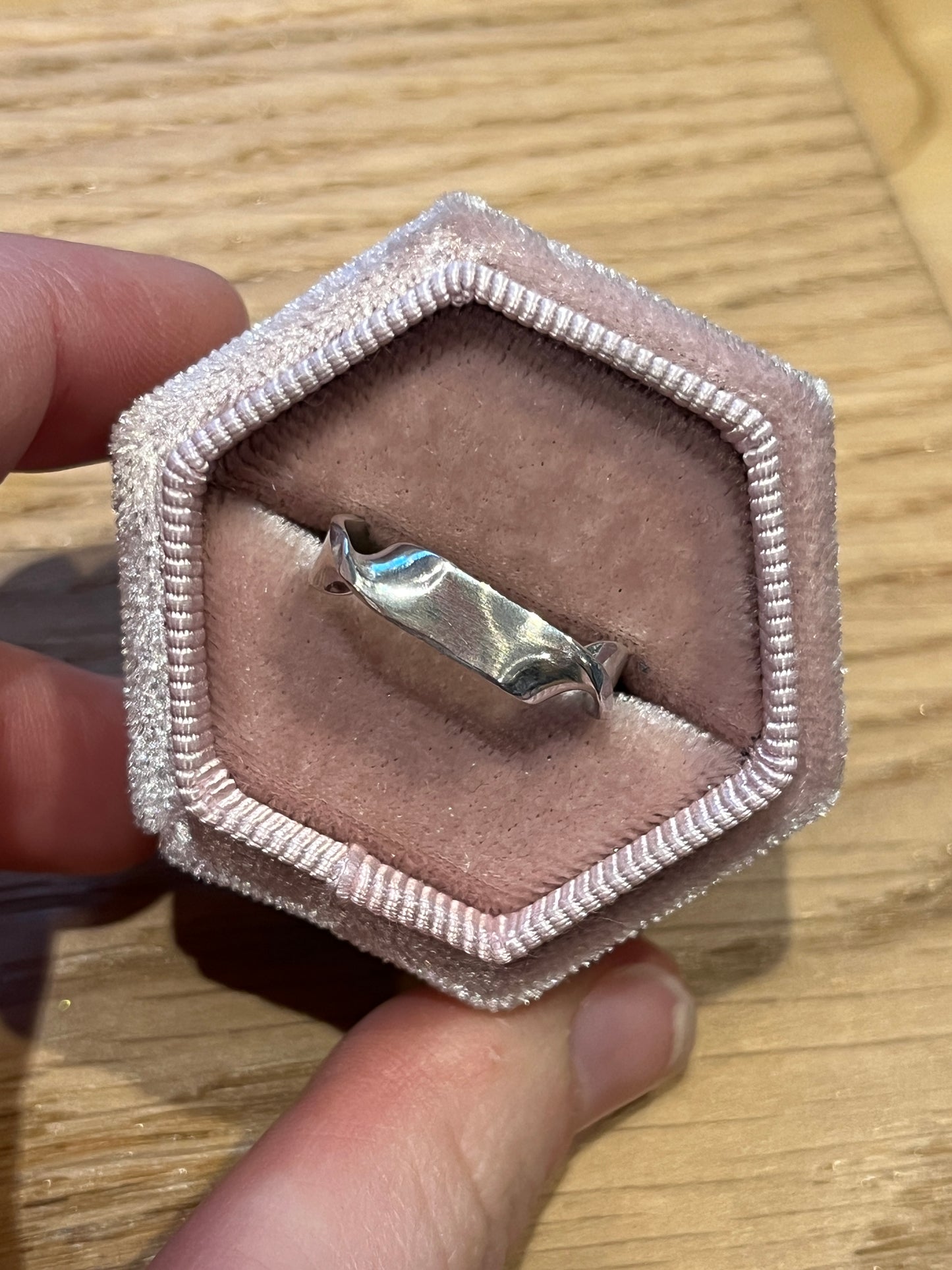 twirl ring 1 in ring box against wood background