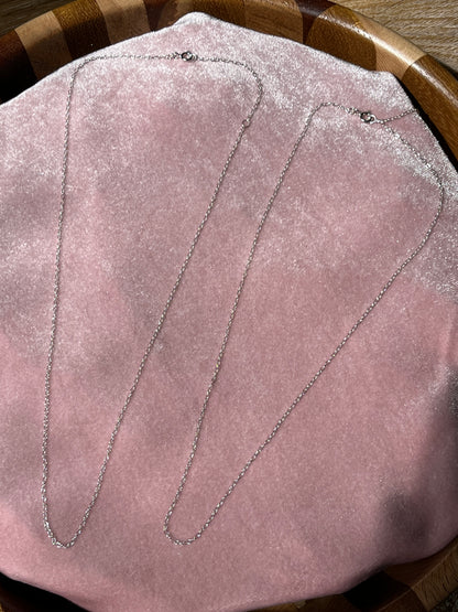 Close-up picture if the 16-18" extendable chain on a pink velvet background