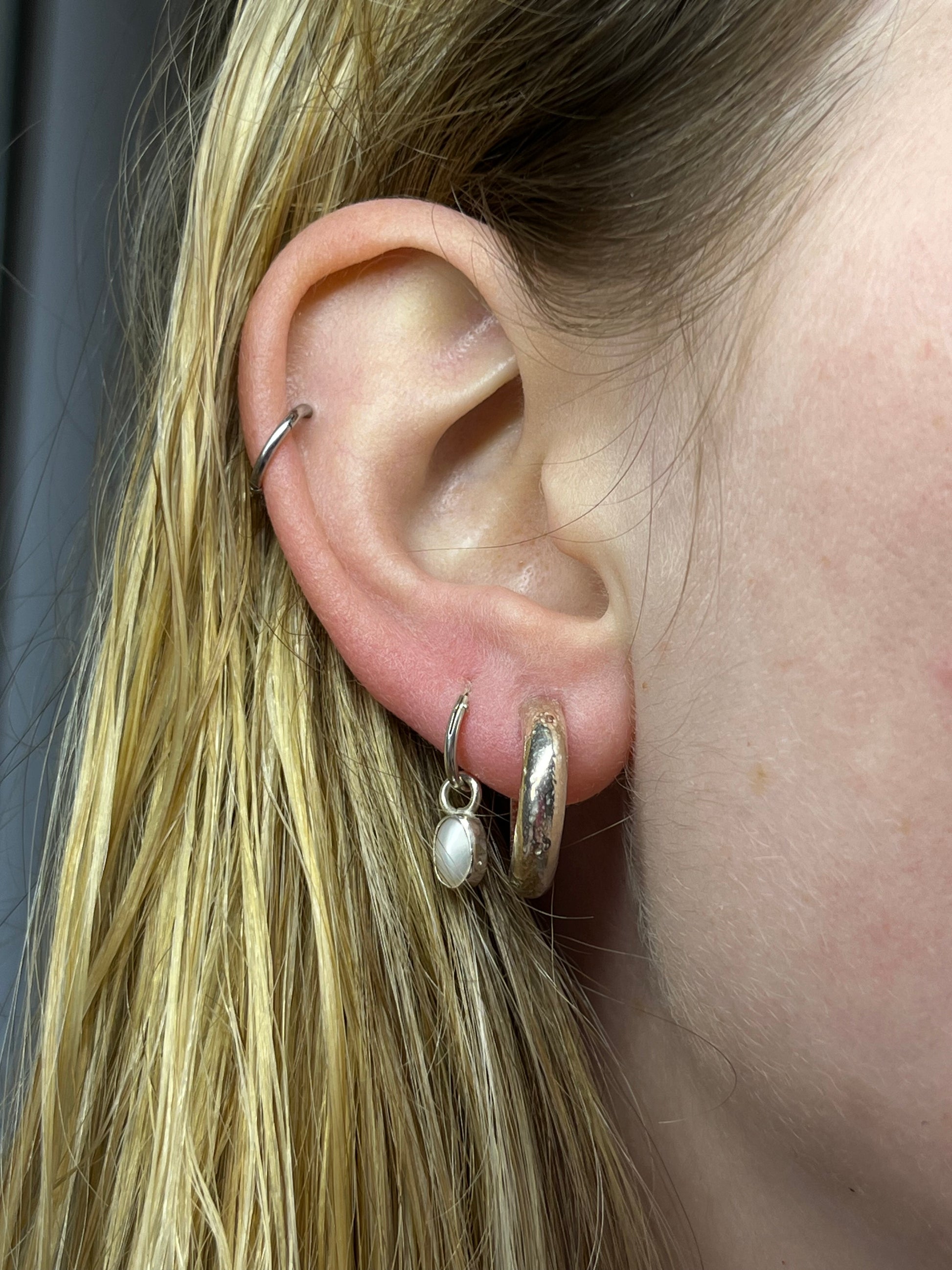 pearl drop and 10mm hoop pictured in ear. Paired with crater hoops.