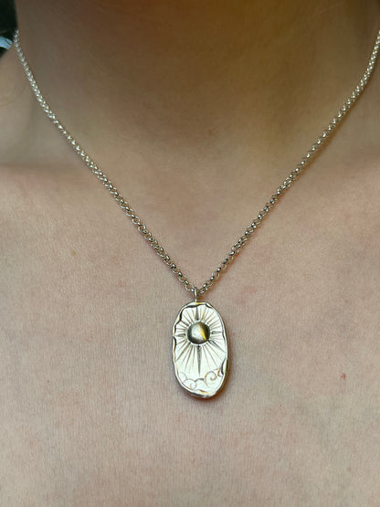 sterling silver pendant featuring beaming sun design pictured on a 16" rolo chian
